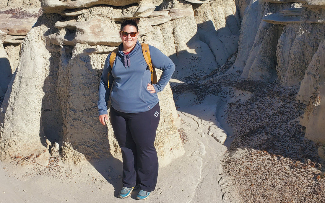 Amanda wears Black Flare Pants and poses for a pic on a desert hike.