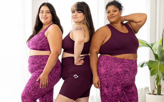 three plus size models smile together