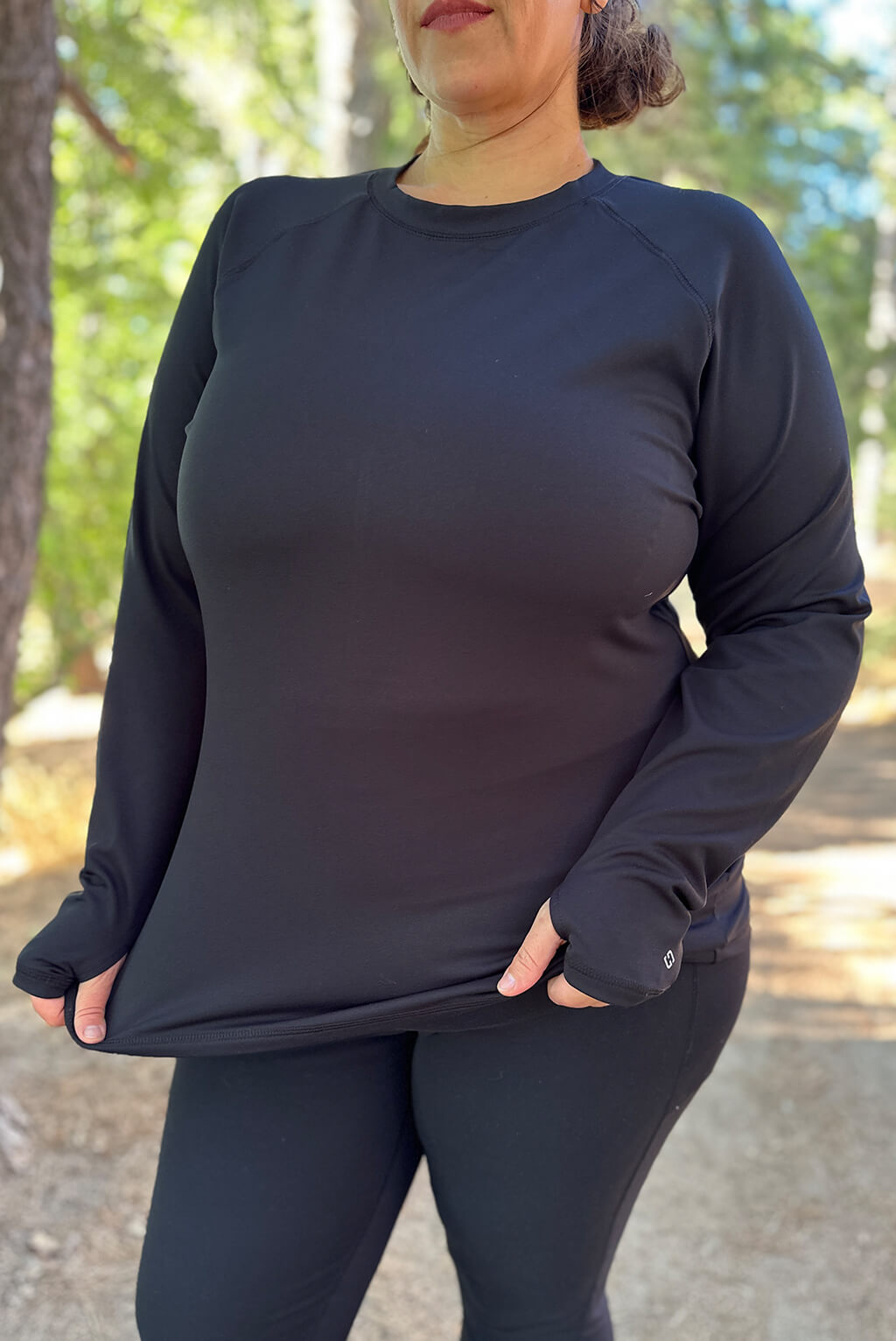 Closeup of long sleeve compression top on model in size 2X.