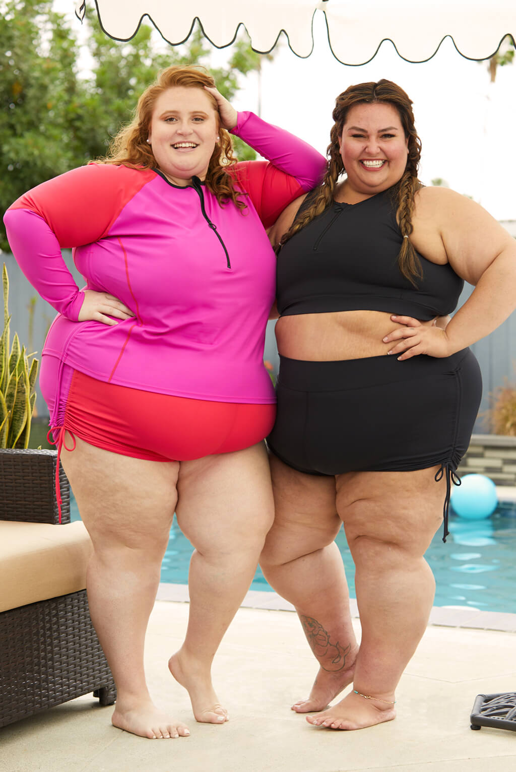 Two plus size women wearing Superfit Hero's Long Sleeve Swim Rash Guard in color Colorblock Fuchsia.