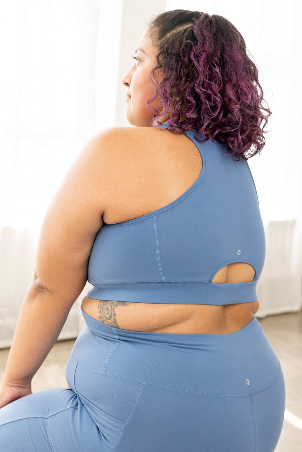 plus size sports bra with a zipper closing front in moonlight blue, back